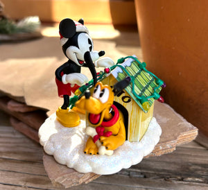 Mickey and Pluto decorating Plutos house for the holidays!