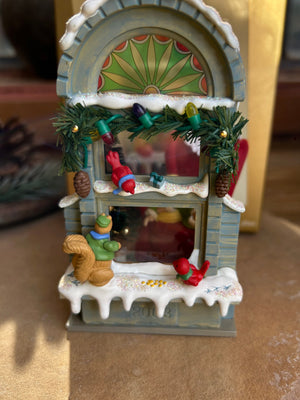 A collectible Christmas window Keepsake ornament featuring holiday figures and decorations, new in box.