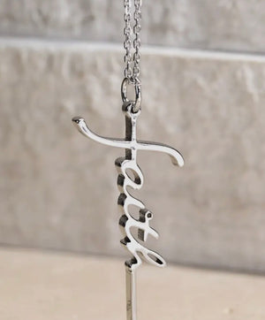 Silver necklace with a unique faith pendant on silvertone background