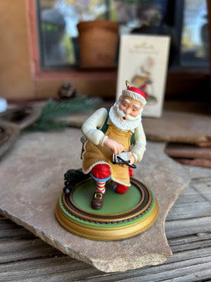 Decorative figurine of a man in a Santa hat on a stone base