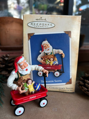 Keepsake Christmas ornament with Toymaker Santa and toys in a red wagon, vintage collectible
