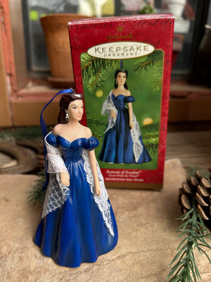 Scarlett Ohara  in a blue dress with a 'Keepsake Collection' book in the background.