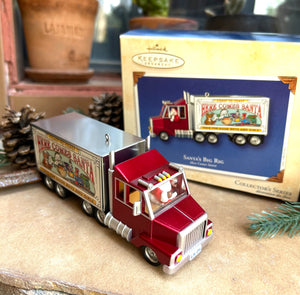 DecorativeSanta's Big Rig  Christmas truck ornament with 'Here Comes Santa' text, displayed in front of its packaging. 25th and final ornament from the Here Comes Santa series