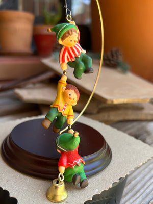 A rare vintage keepsake ornament from 1980 features three colorful and vibrant lil elves working together to finish  the Christmas decorating. 
Exquisite details and a huge collectors dream 