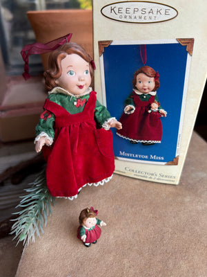 Two dolls in red and green outfits 'Keepsake ornament set, third and final doll in the Mistletoe Miss Madame Alexander Series 