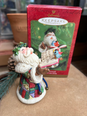 Toy Shop Serenade Santa singing Christmas carols and wearing a colorful patchwork suit  Christmas ornament with a book keepsake ornament