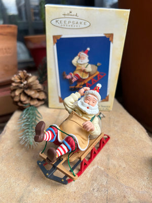 Christmas ornament of Toymaker Santa Claus working on a sled, 6th in the Toymaker Santa Collection a Hallmark Keepsake Ornament box.