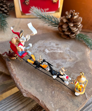 Hallmark Keepsake Looney Tunes ornament featuring bugs bunny, tweety, daffy, sylvester and Taz riding a sled full of gifts vintage new in box
