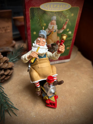 Hallmark Keepsake Toymaker Santa  ornament the first in the Toymaker Series features Santa riding on a toy train with toys on each hand. new in box vintage collectible from 2000