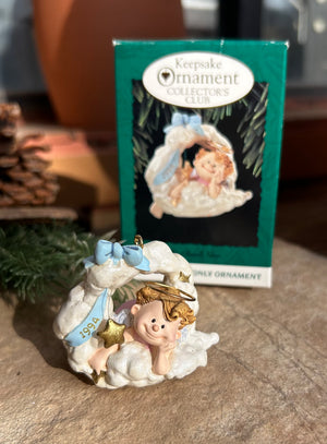 A Hallmark Keepsake collector's ornament featuring an angel on cloud nine with 1994 gold tone lettering, packaged in its original box.